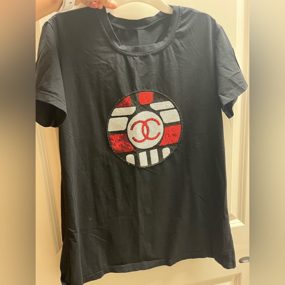 Chanel shirt sequin on the logo.